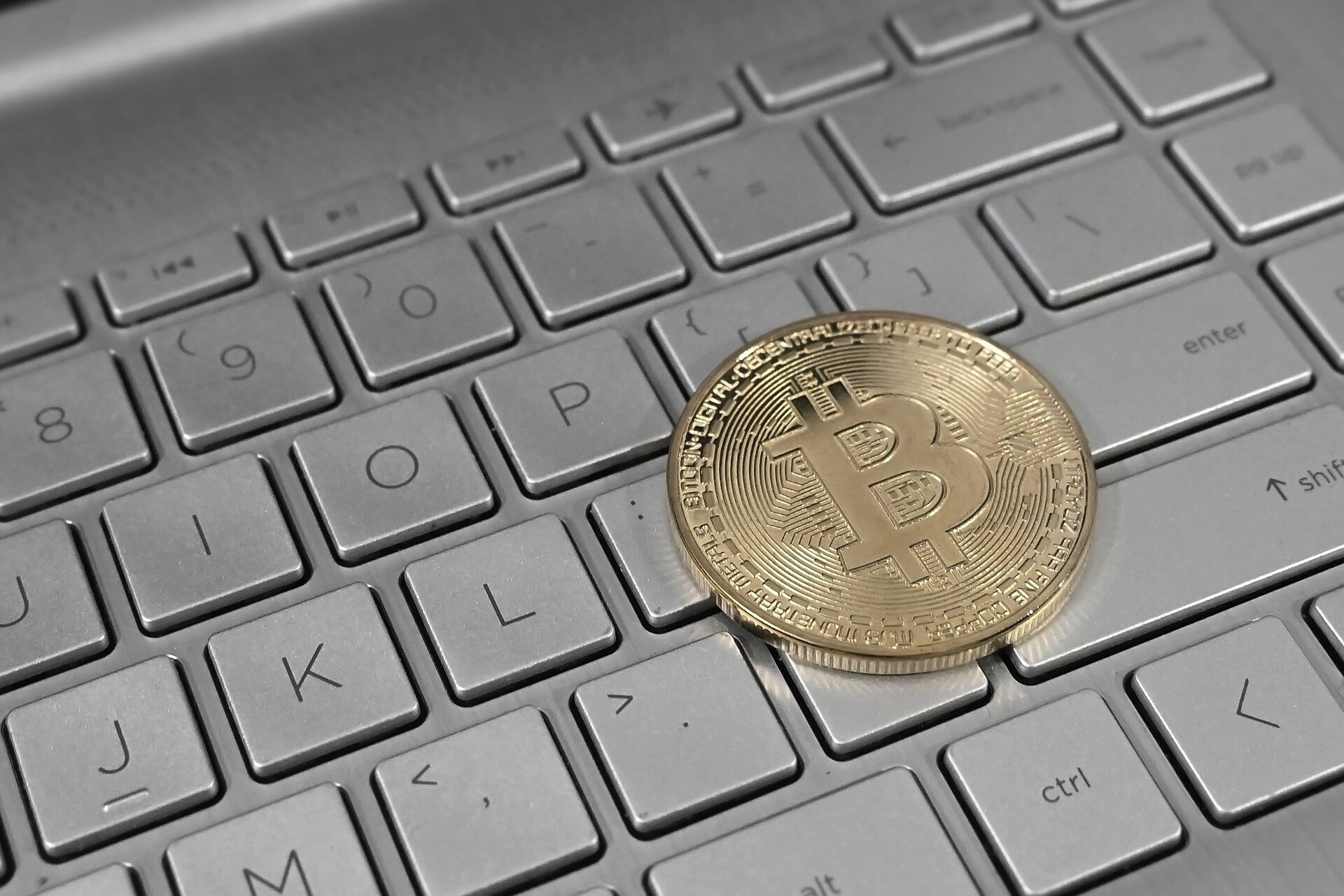 A physical bitcoin coin on a keyboard
