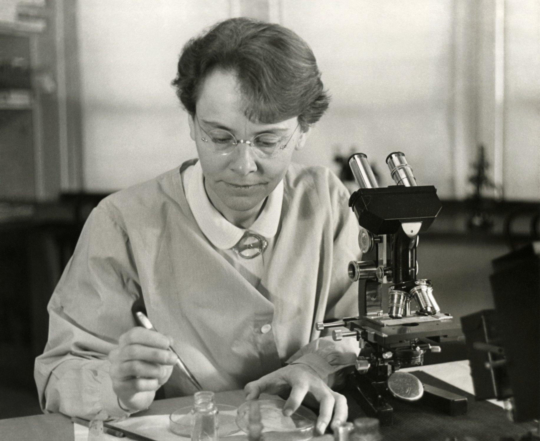 A scientist at a laboratory microscope