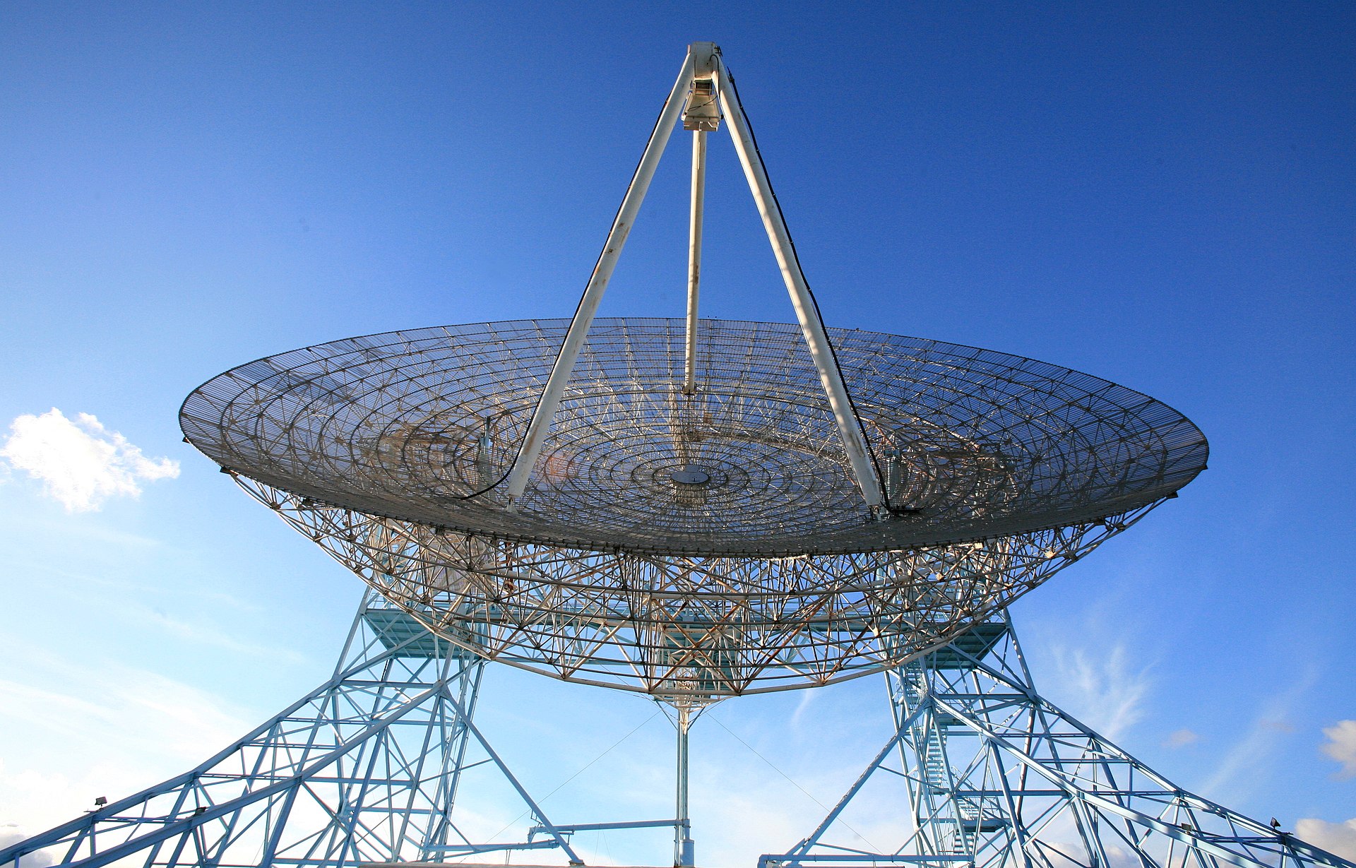 A radio telescope dish against a night sky