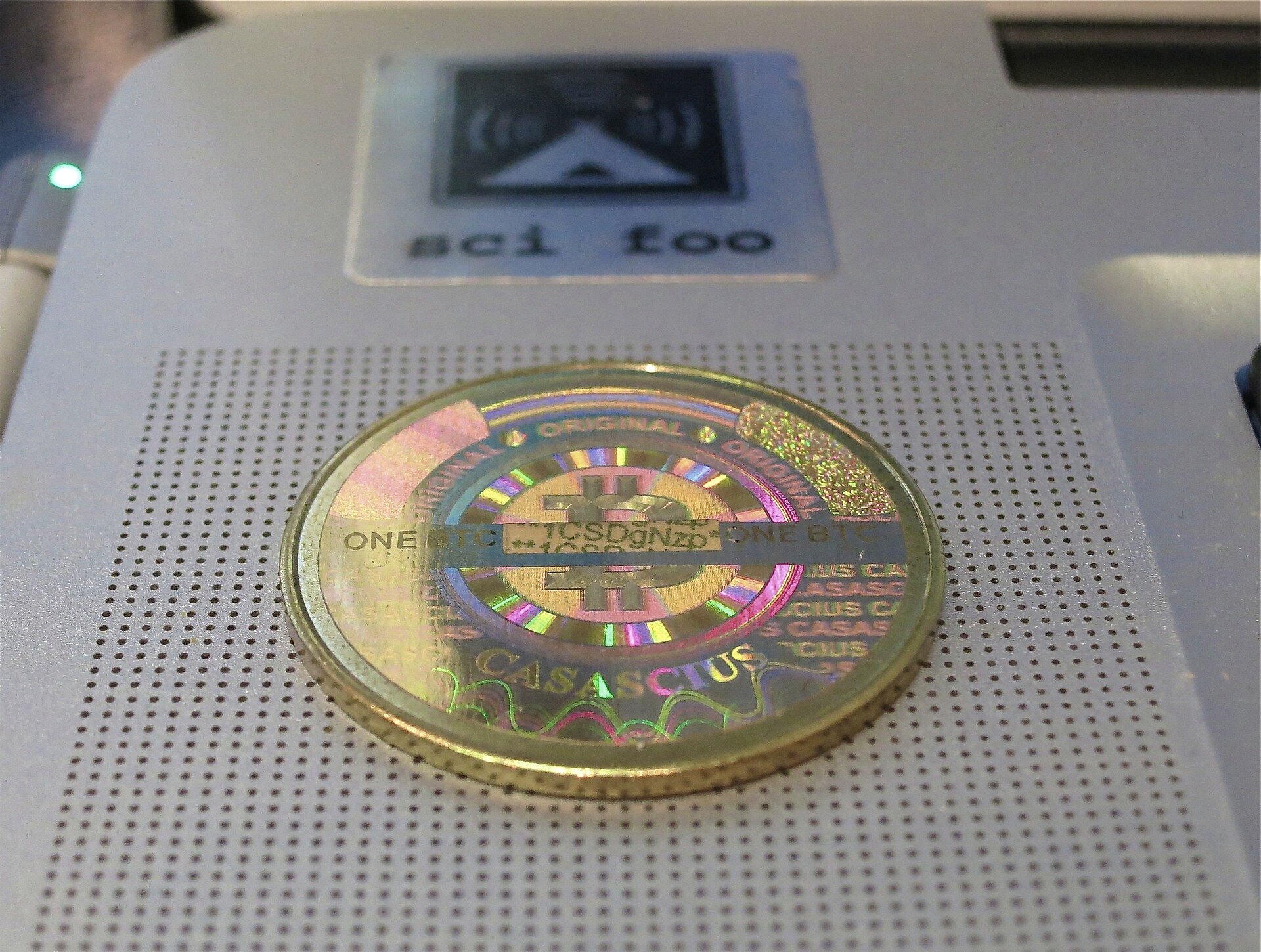 A digital bitcoin coin above a global network grid