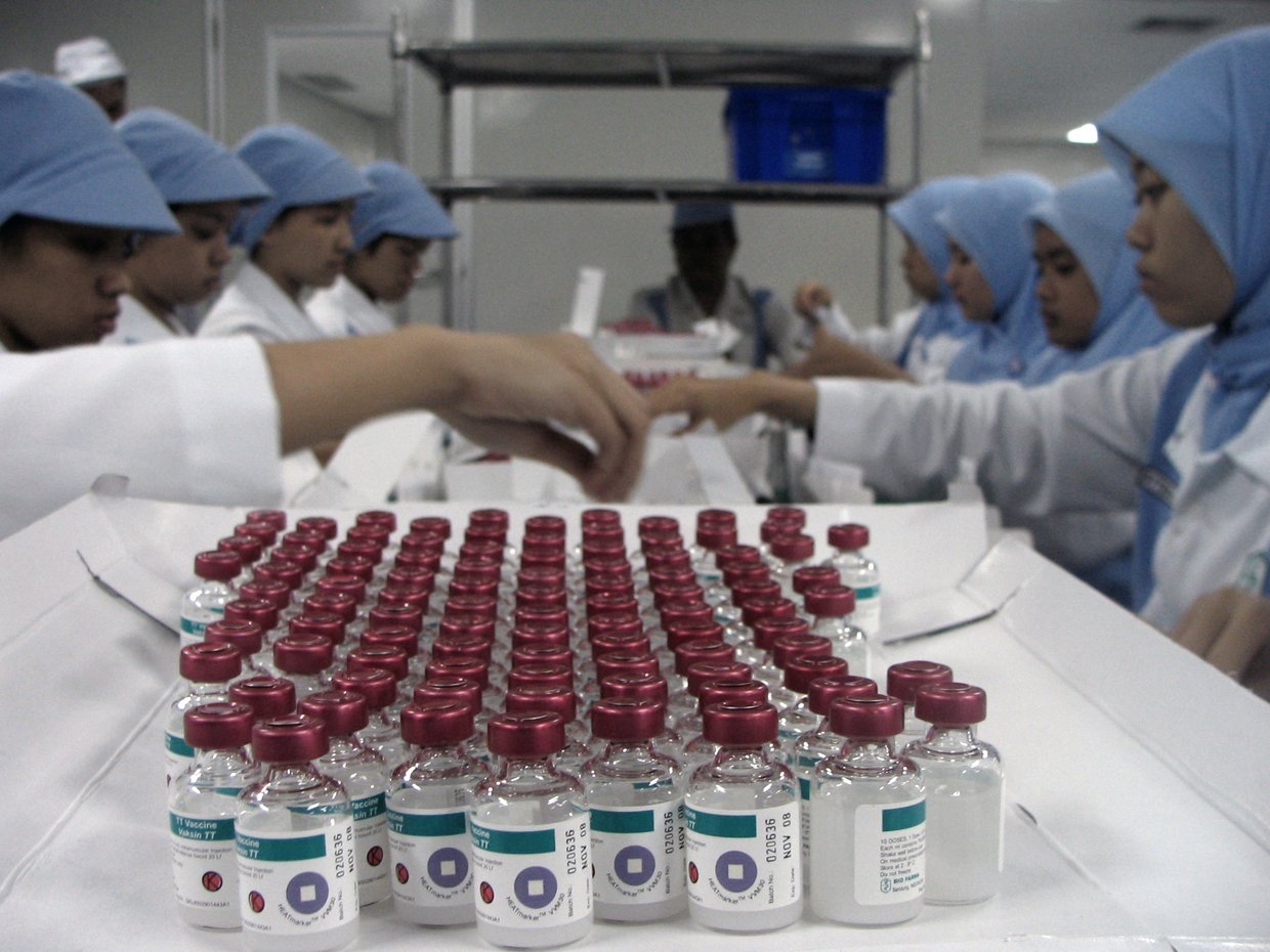 A laboratory researcher at a microscope