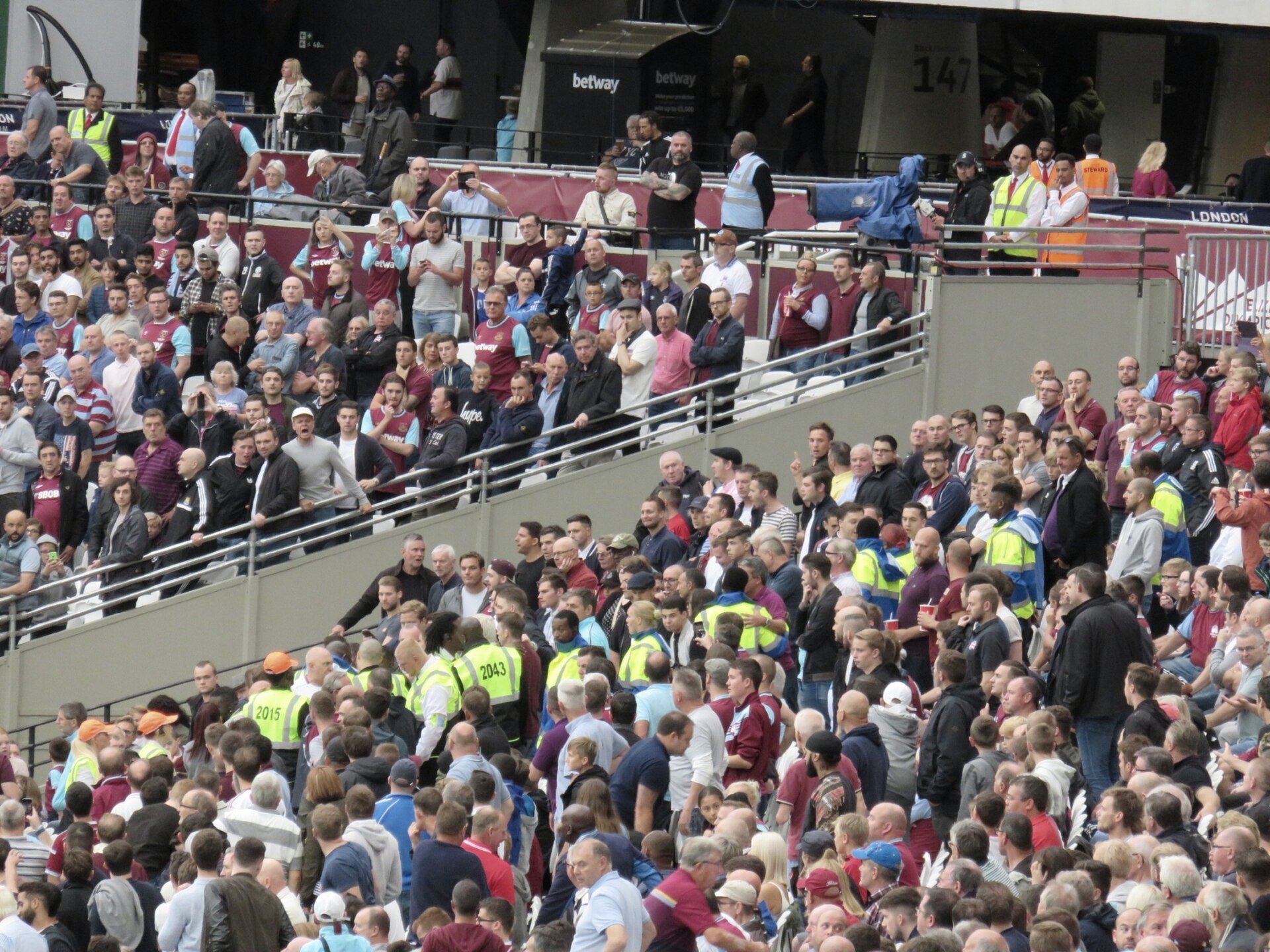 A packed stadium crowd under floodlights