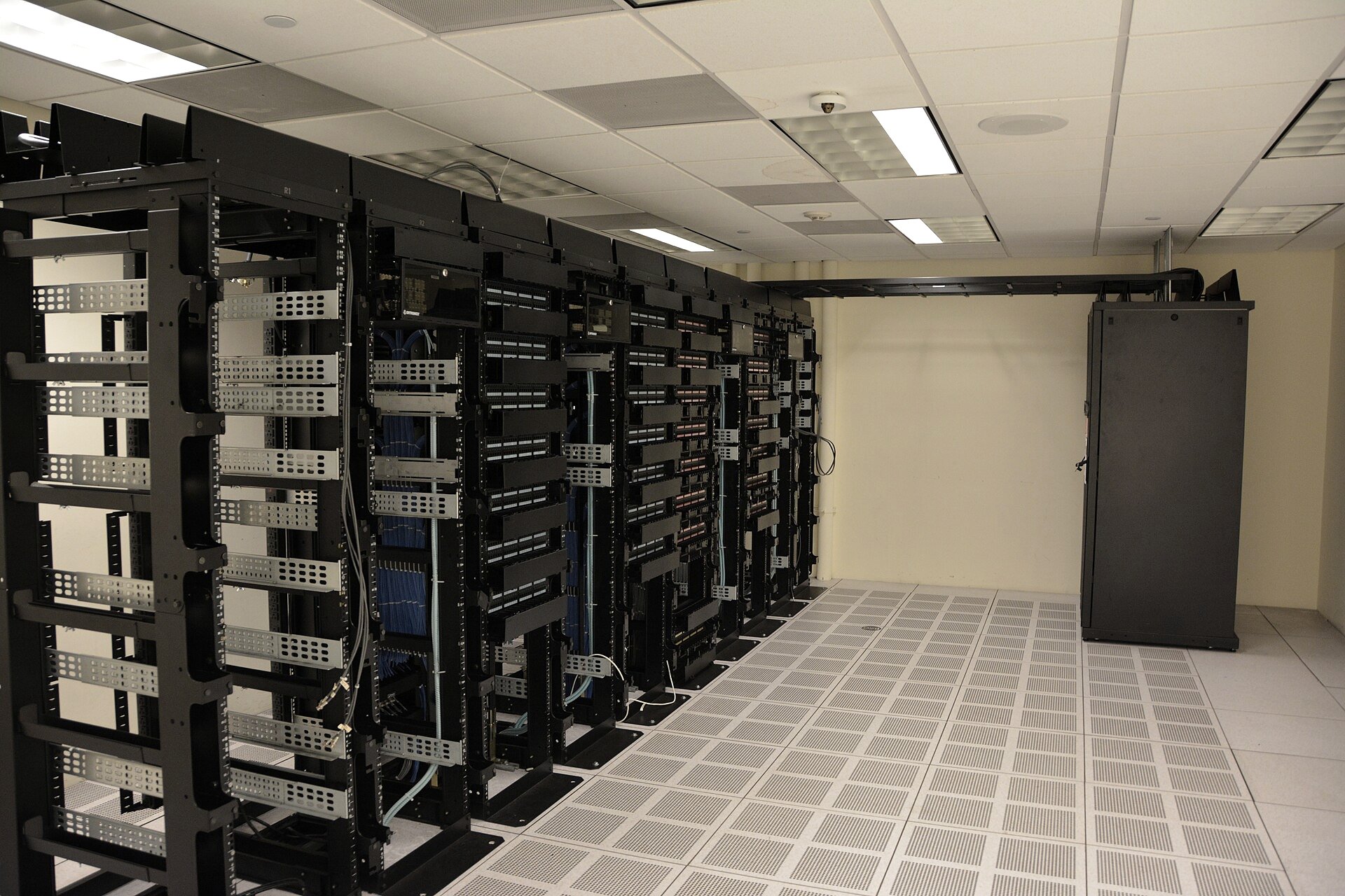 A chip fabrication clean room with technicians in white suits